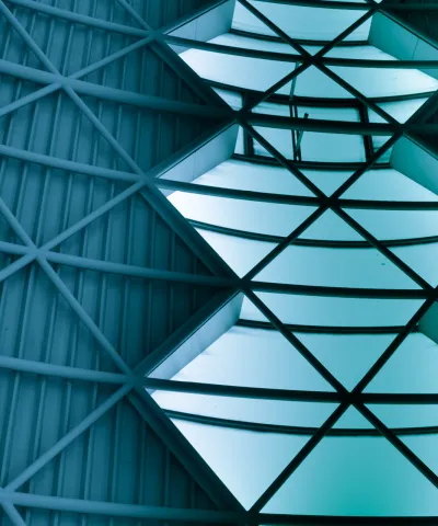 Green transition: An image of open sky seen through gaps in a steel roof